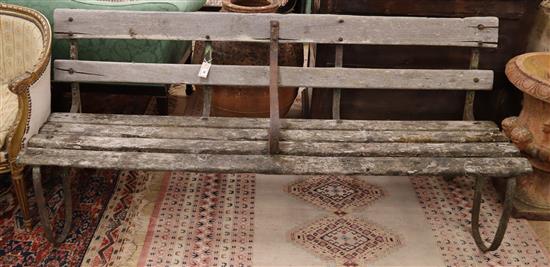 A slatted wrought iron garden bench, W.185cm., D.64cm., H.80cm
